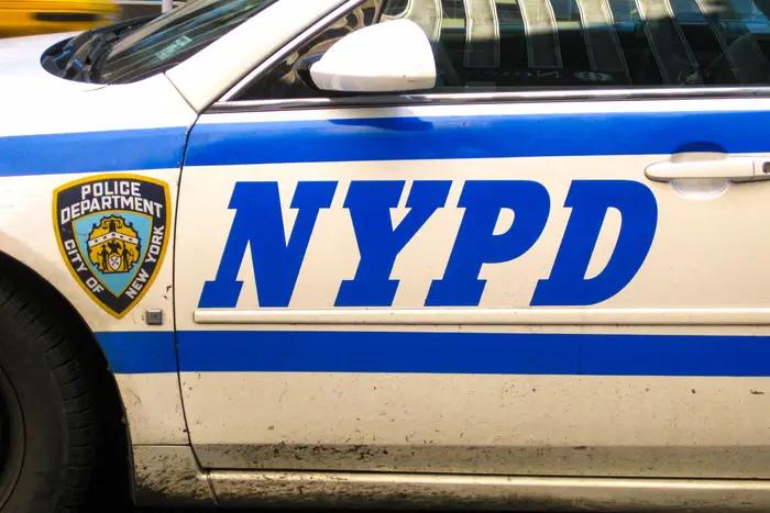 Close up of the badge on the side of a New York police department patrol car.